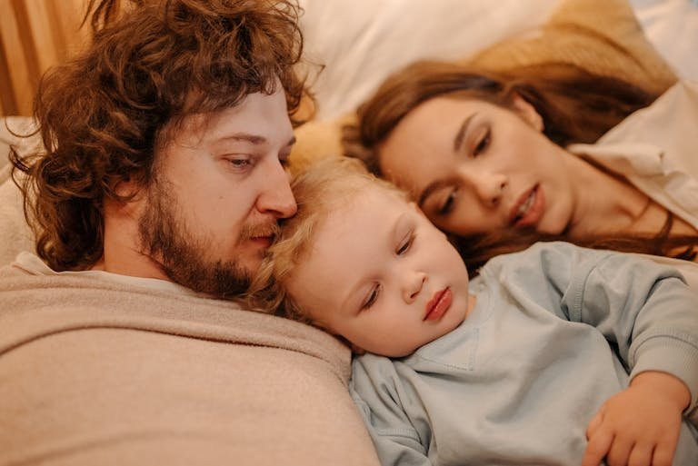 Family enjoying a cozy moment together on the couch, depicting warmth and closeness.